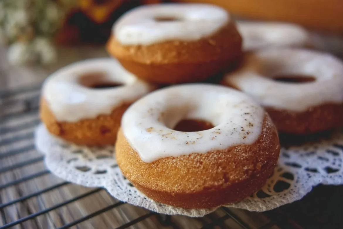 Freshly baked apple donuts with cinnamon glaze on a plate