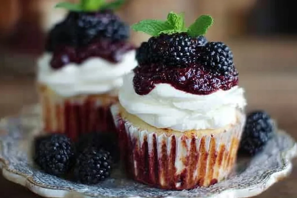 Delicious Blackberry Bourbon Smash Cupcakes topped with fresh blackberries and bourbon frosting.