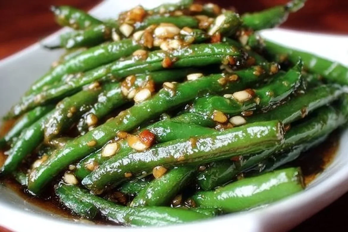 Chinese green beans tossed in garlic sauce for a delicious meal.