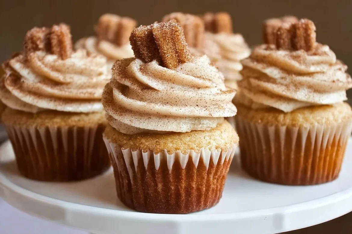 Cinnamon sugar churro cupcakes topped with frosting and a sprinkle of cinnamon