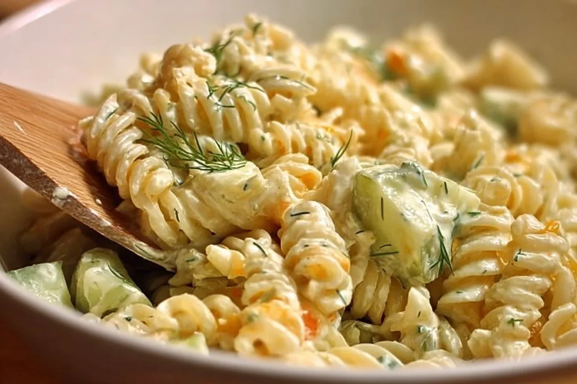 Creamy dill pickle pasta salad with fresh ingredients in a bowl