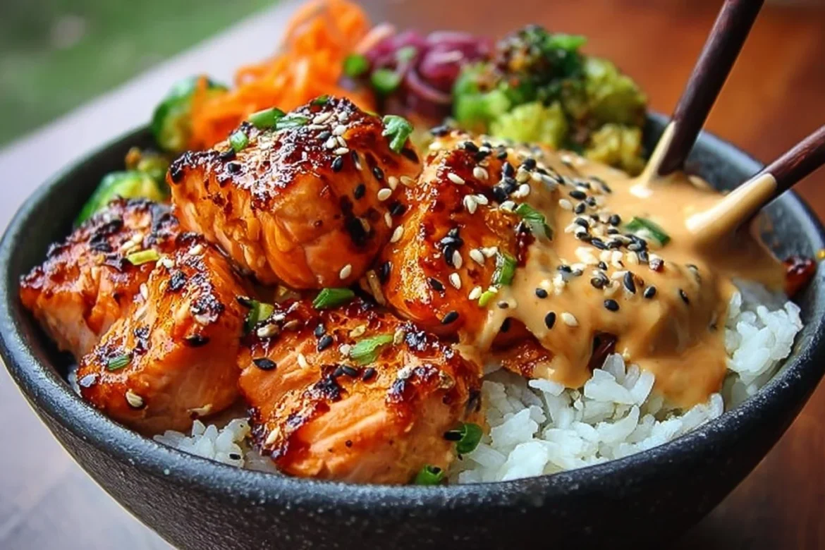 Delicious Sriracha Honey Salmon bowls garnished with vegetables and rice.