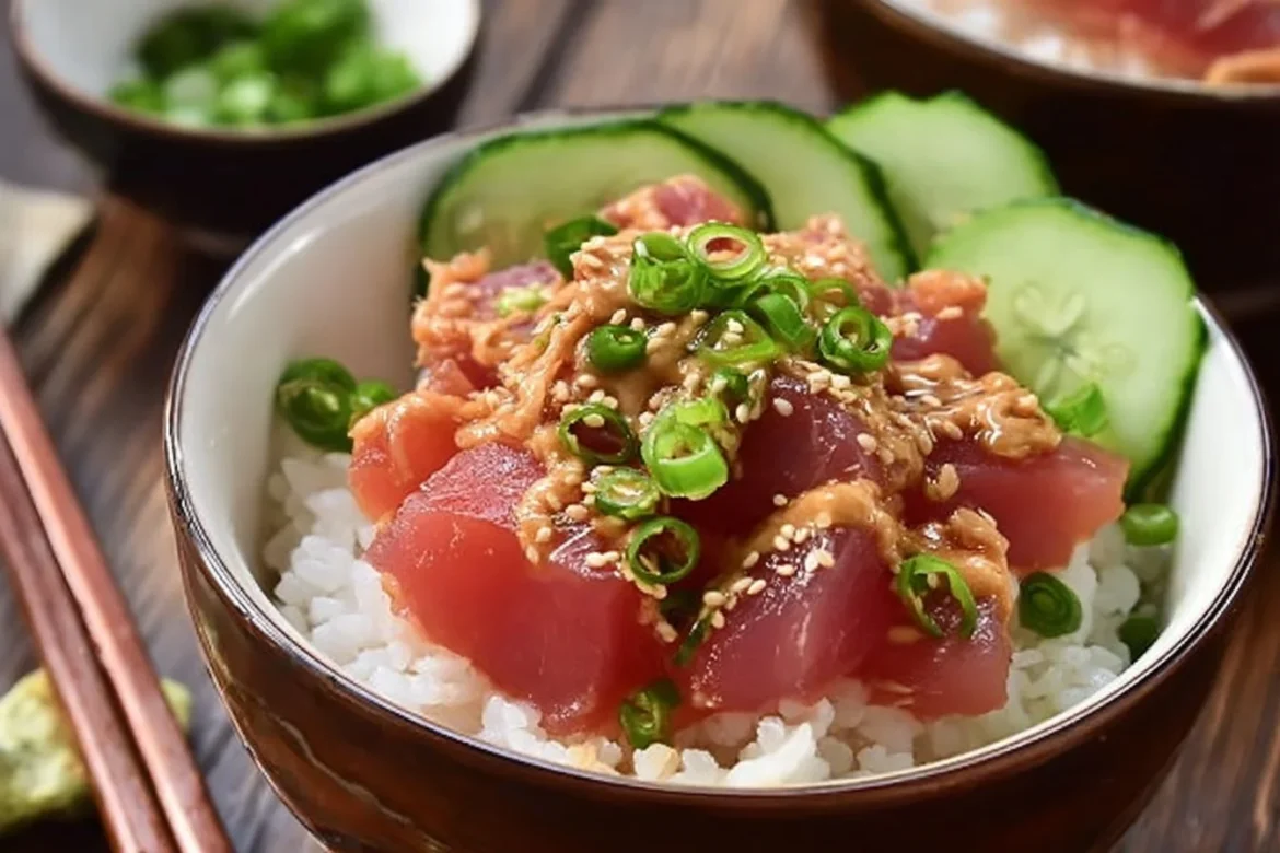 Canned tuna sushi bowl garnished with avocado and sesame seeds.