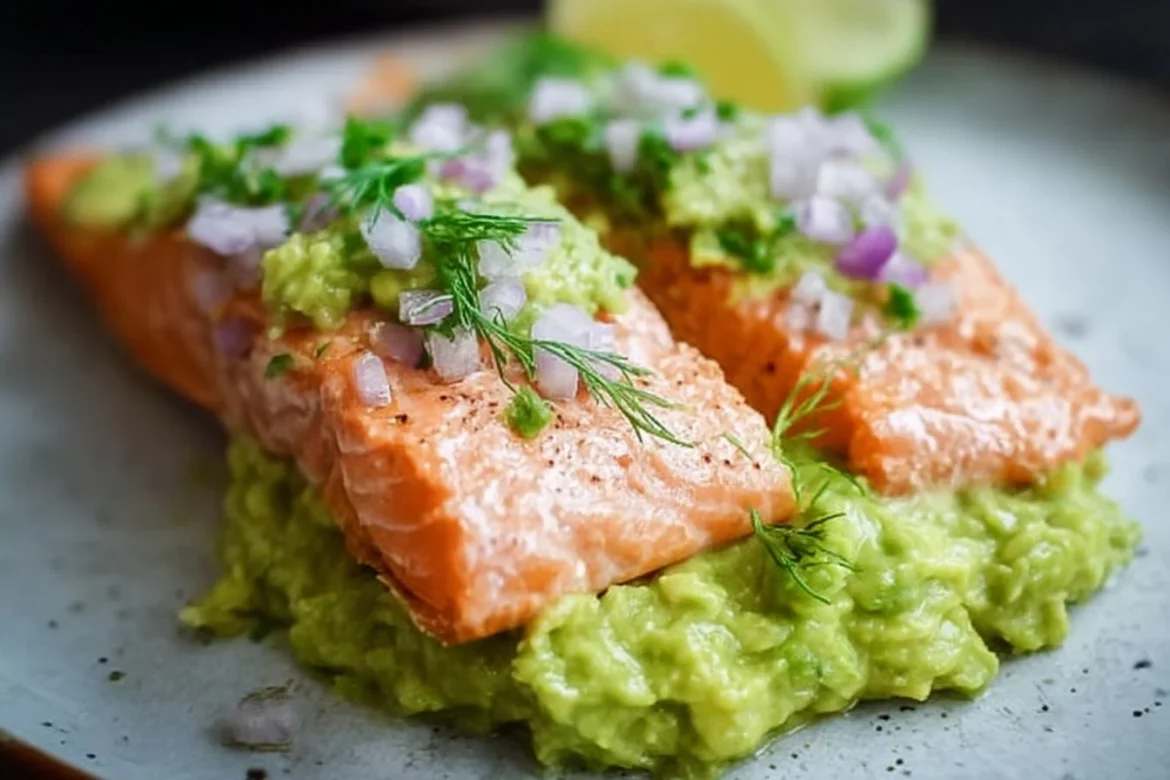 Baked salmon fillet served with a side of creamy avocado mash