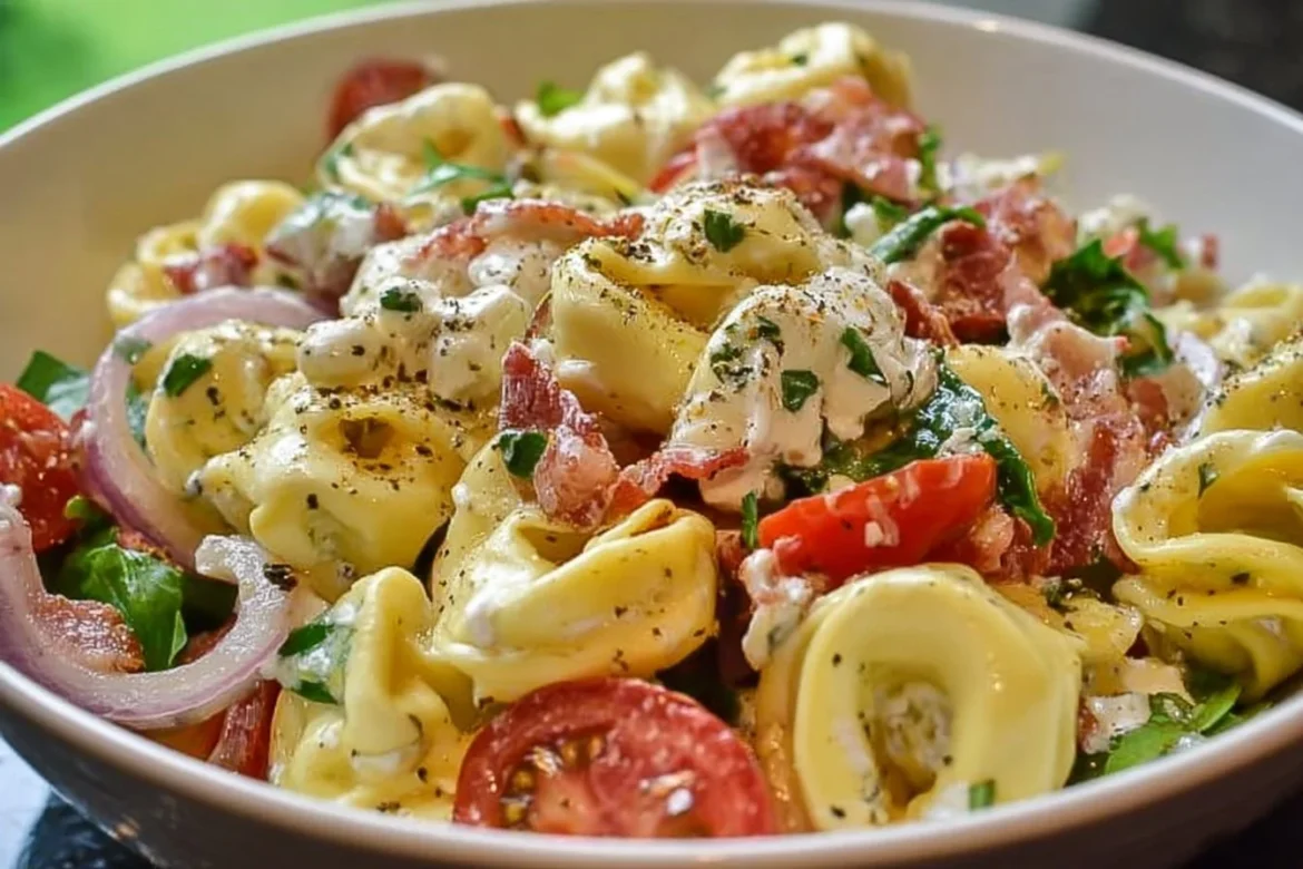Colorful Grinder Tortellini Salad with vegetables and dressing in a bowl