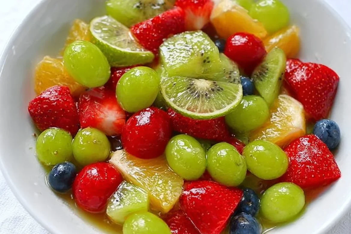 Colorful honey lime fruit salad with mixed fruits in a bowl