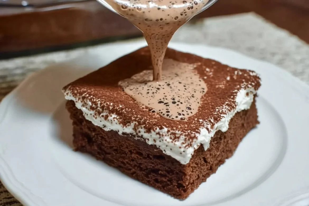Delicious Chocolate Tres Leches Cake topped with creamy frosting and chocolate shavings.