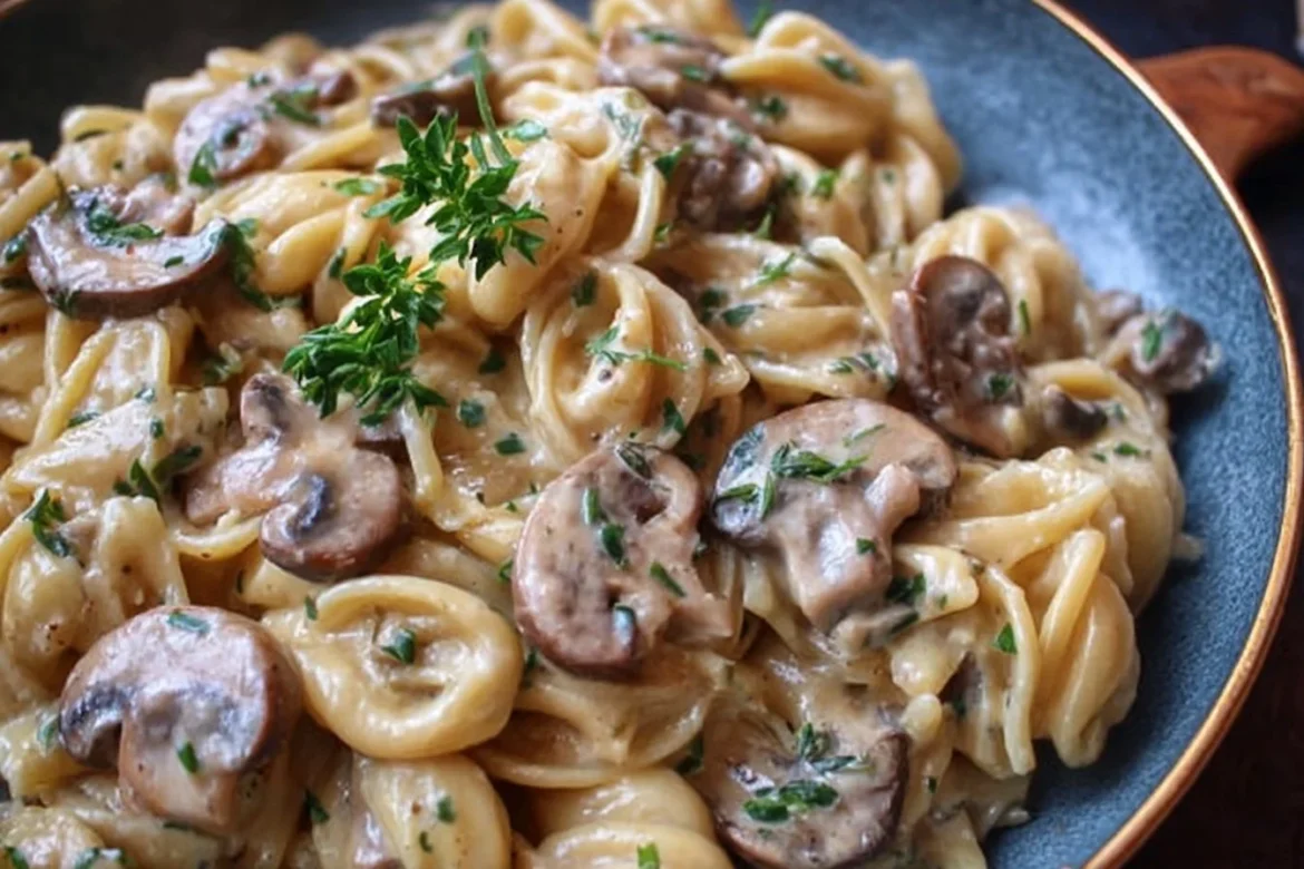 Plate of creamy mushroom marsala pasta with fresh herbs and a rich sauce.