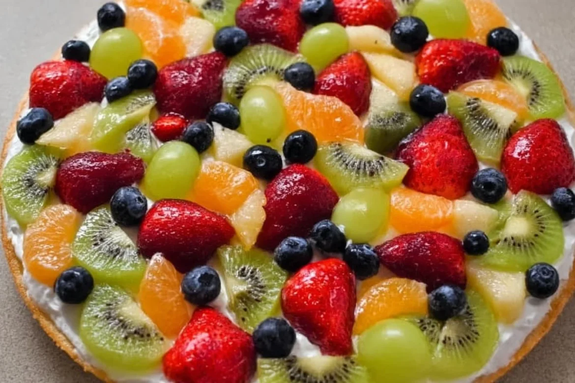 Colorful fruit pizza with homemade crust topped with fresh fruits.