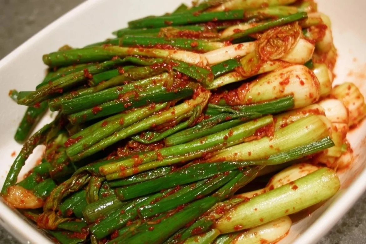 A vibrant bowl of Green Onion Kimchi with fresh ingredients and rich colors.