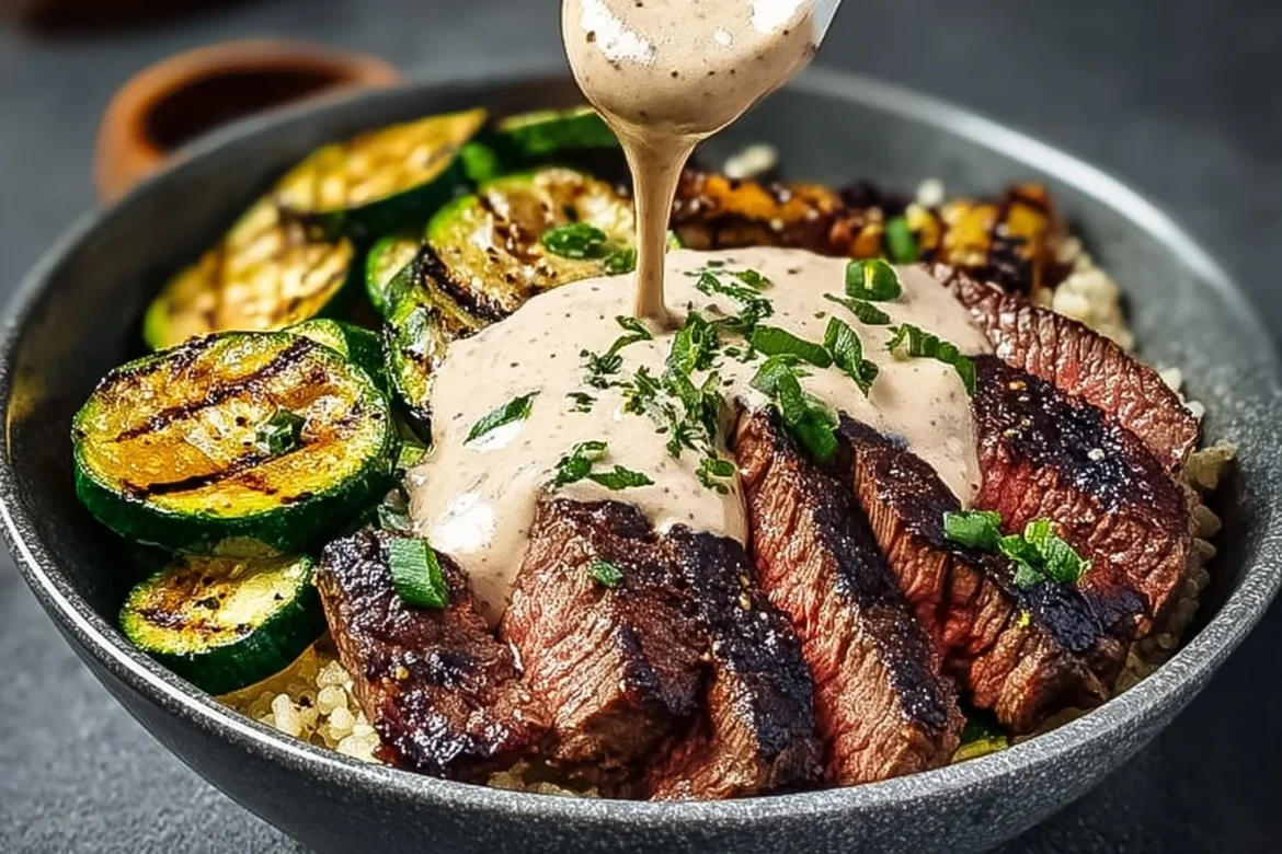 Delicious grilled steak bowl with creamy sauce and grilled zucchini on a plate