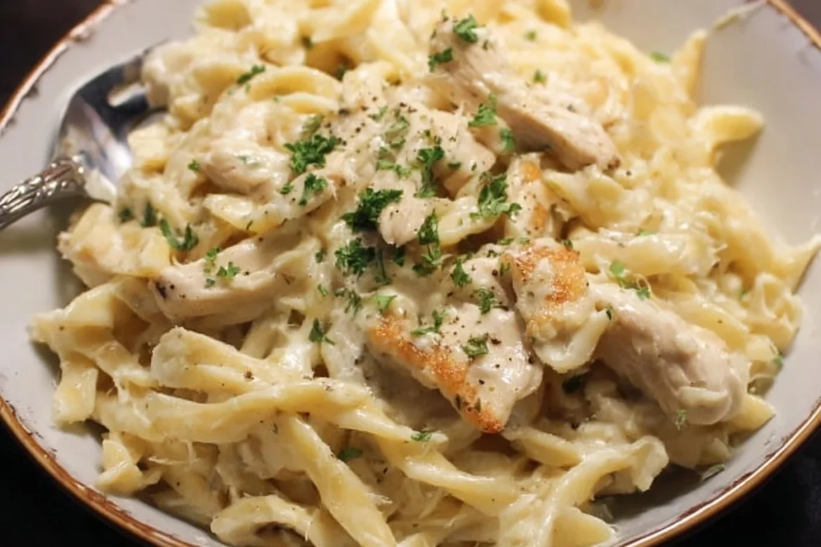 Creamy Instant Pot Chicken Alfredo served with parsley garnish