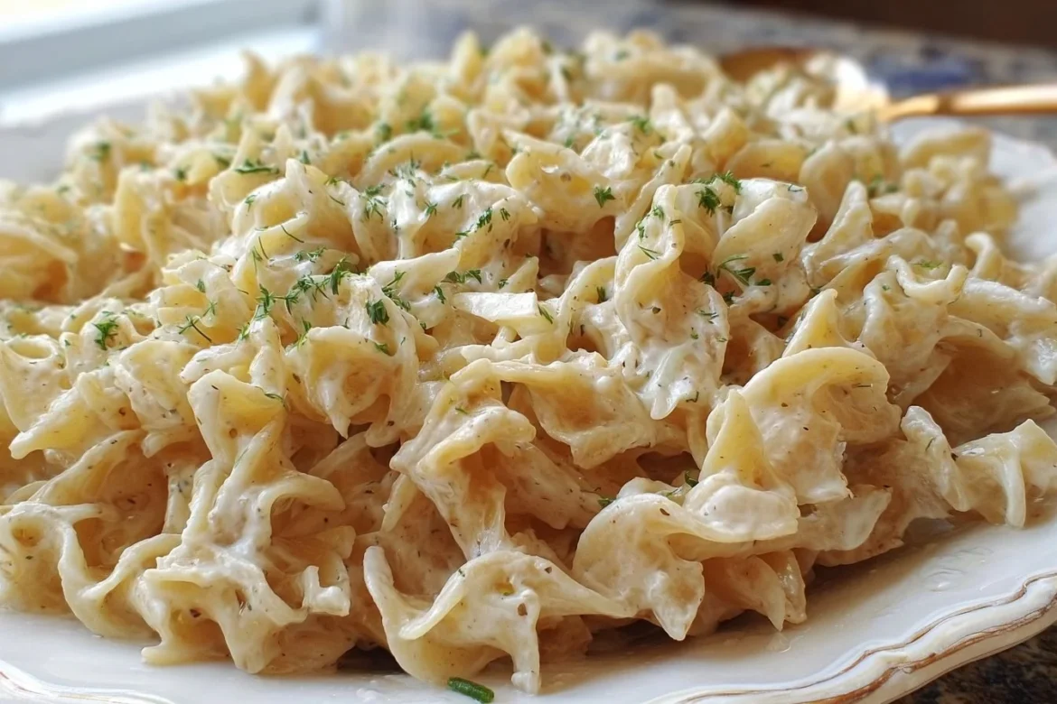 Plate of Polish noodles with sour cream and caramelized onions
