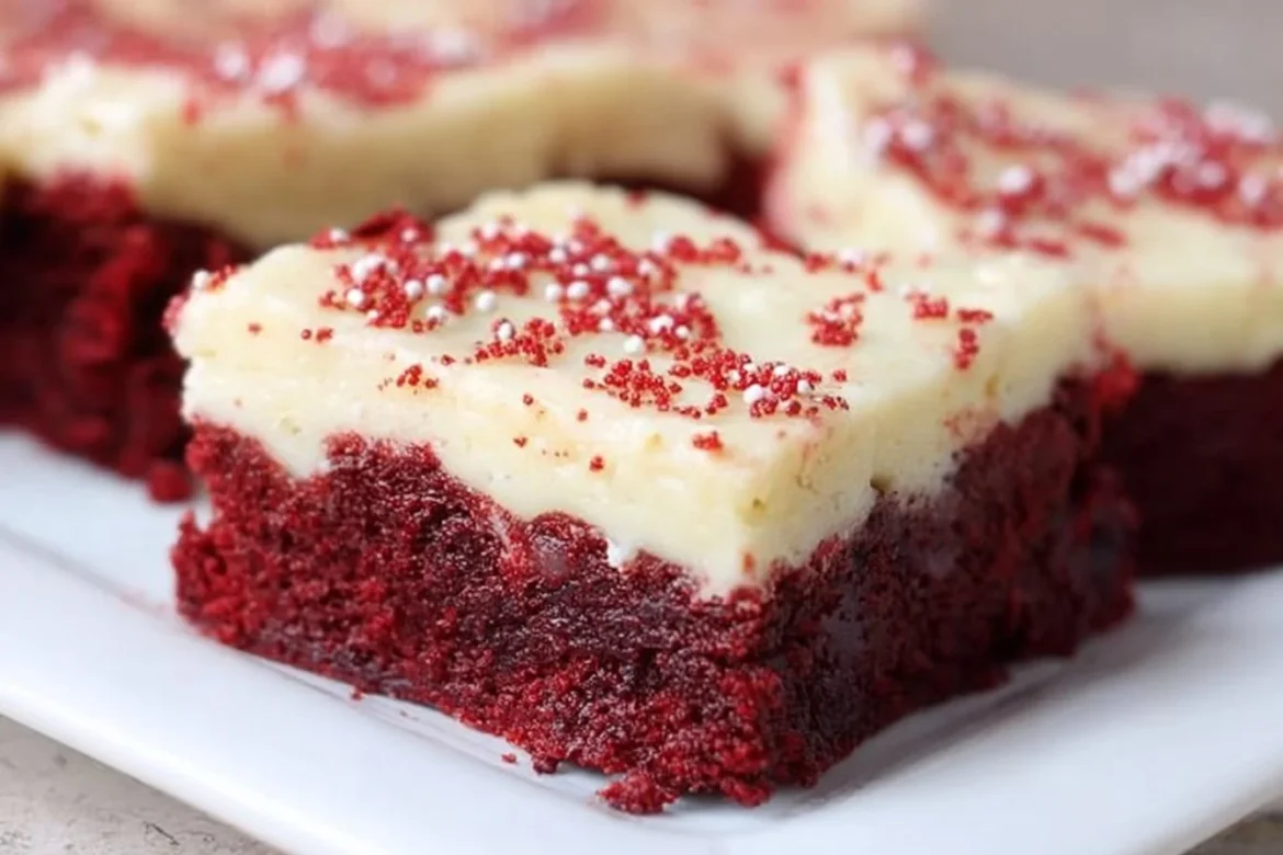 Delicious red velvet cookie bars topped with cream cheese frosting.