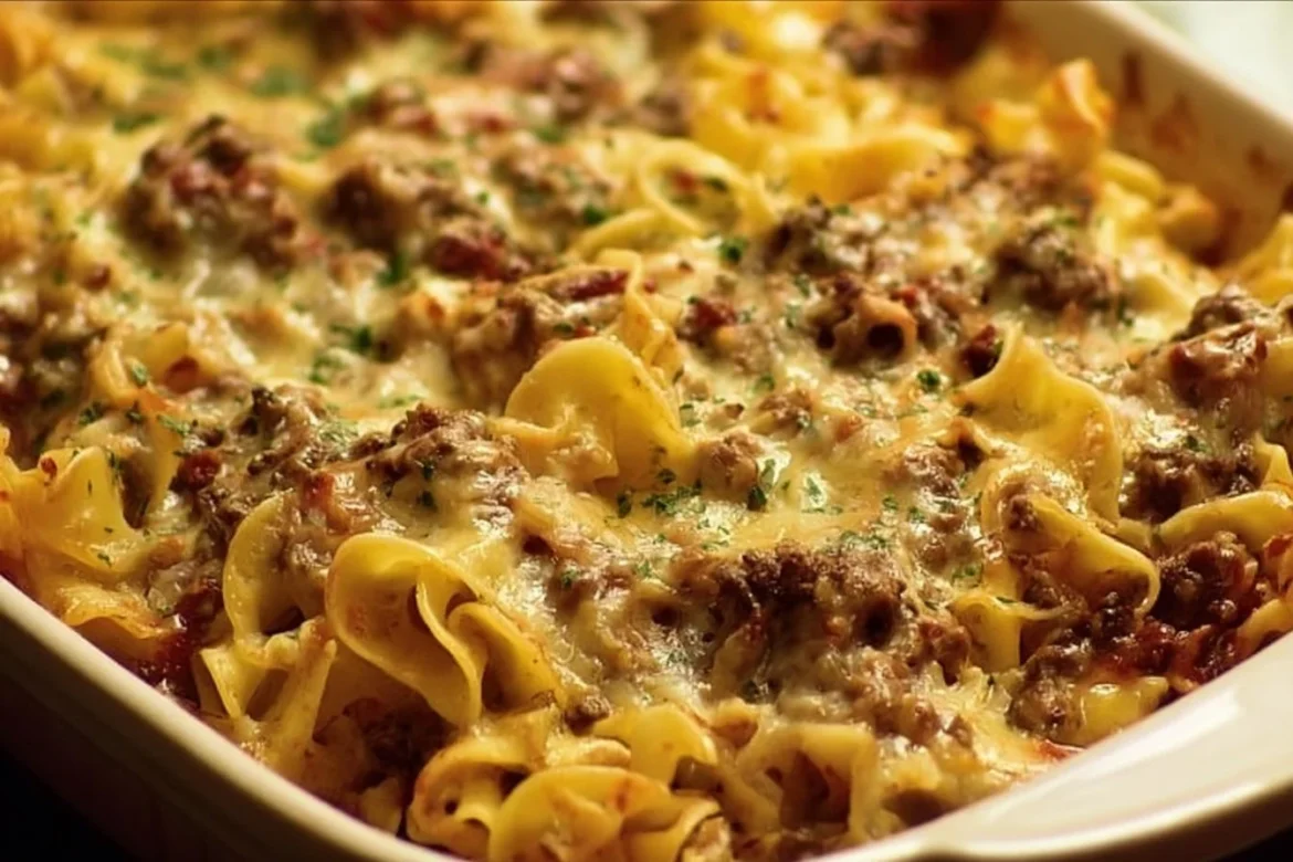 Sour Cream Beef Noodle Casserole topped with cheese and herbs