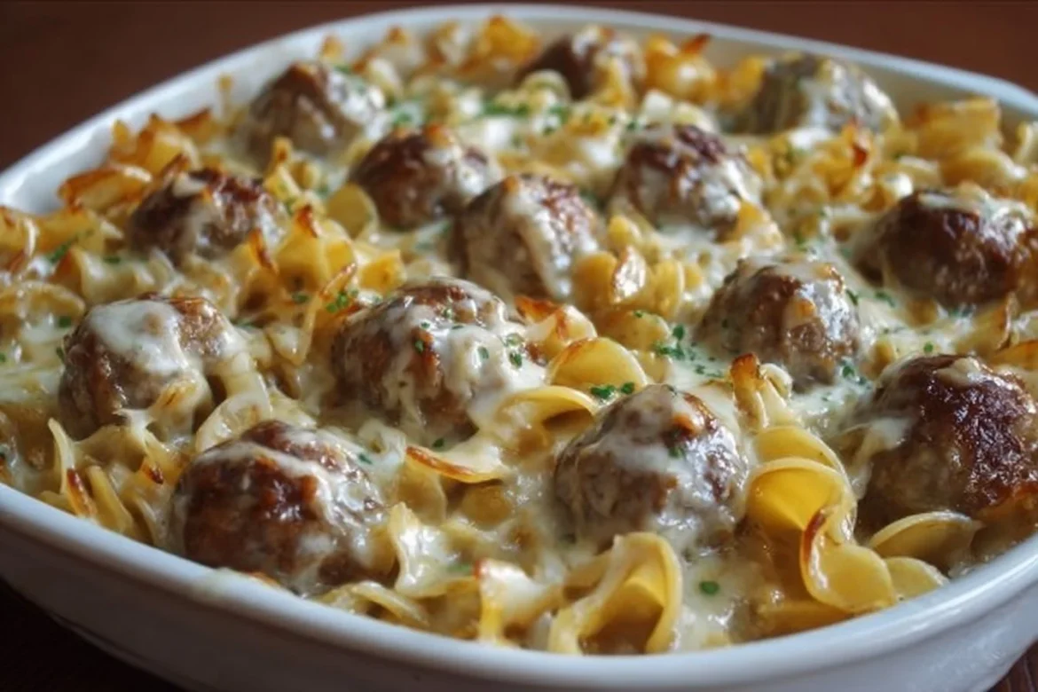 Swedish meatball noodle bake topped with cheese in a casserole dish