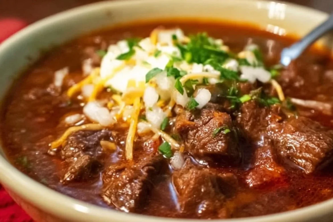 A hearty bowl of Texas beef brisket chili topped with green onions and jalapenos