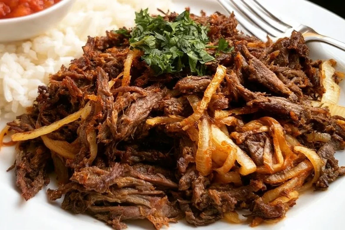 Plate of authentic Cuban Fried Beef garnished with fresh herbs