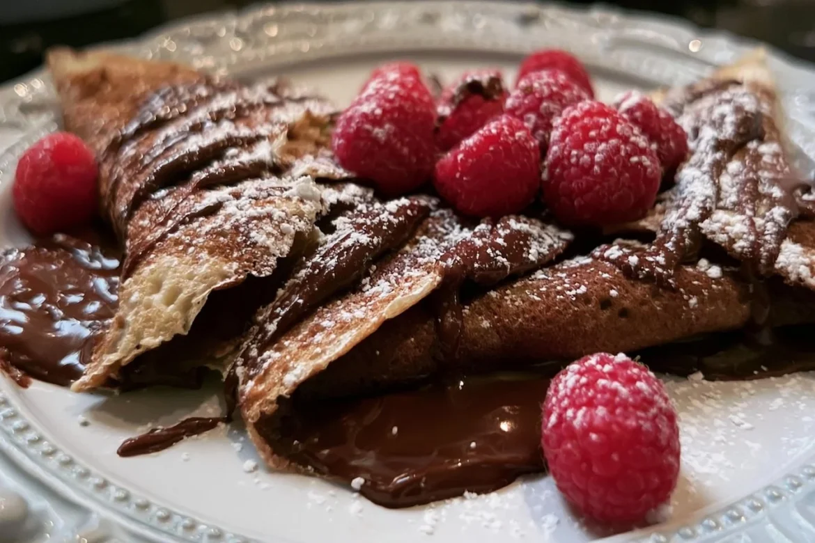 Delicious Chocolate Raspberry Crepes with fresh raspberries and chocolate drizzle
