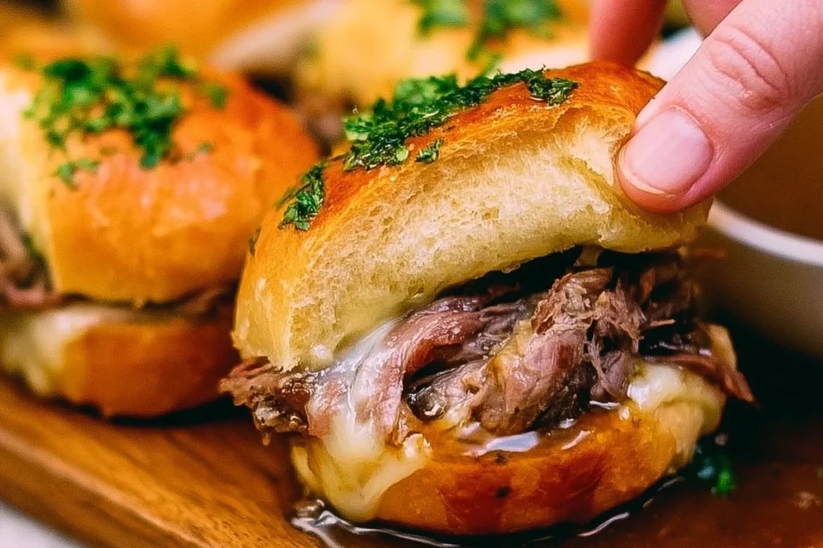 French Dip Sliders served with dipping sauce on a rustic plate