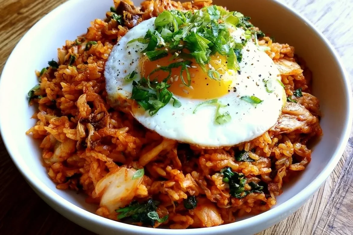 Delicious plate of Kimchi Fried Rice garnished with green onions and sesame seeds