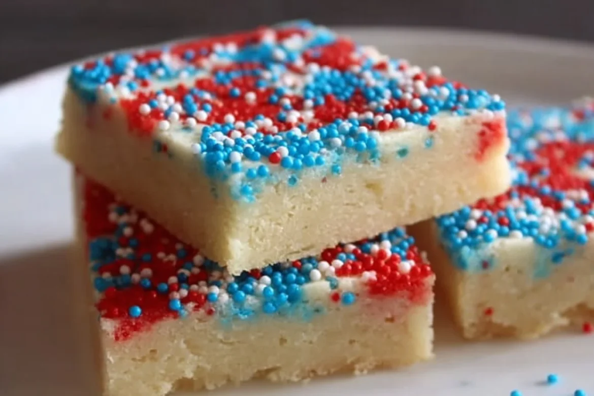 Patriotic sugar cookie bars decorated in red, white, and blue sprinkles.