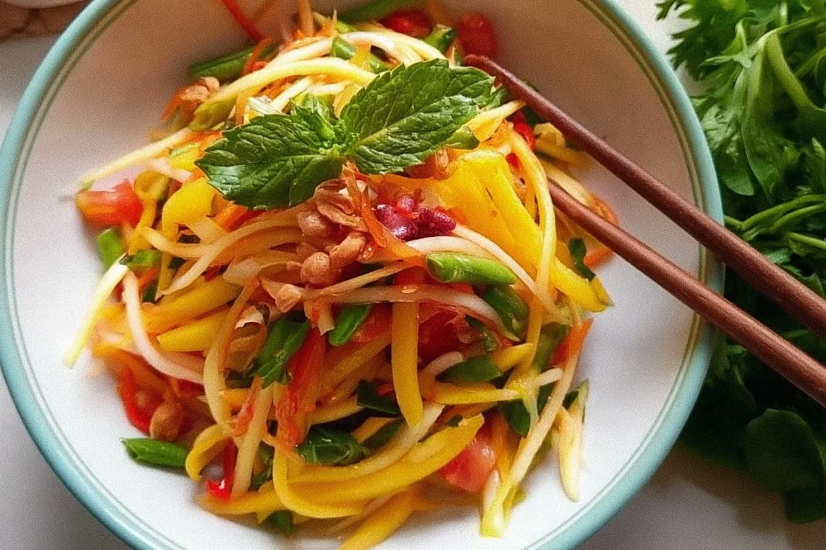 A vibrant Thai Mango Salad with fresh mango, herbs, and vegetables.