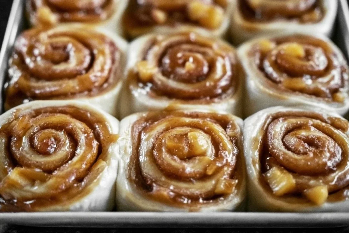 Freshly baked caramel apple cinnamon rolls drizzled with caramel sauce