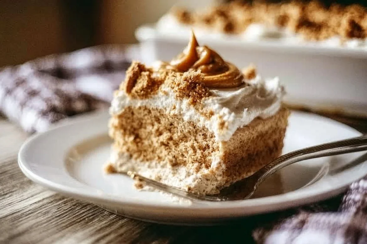 Delicious cookie butter tres leches cake topped with whipped cream and cookie crumbs