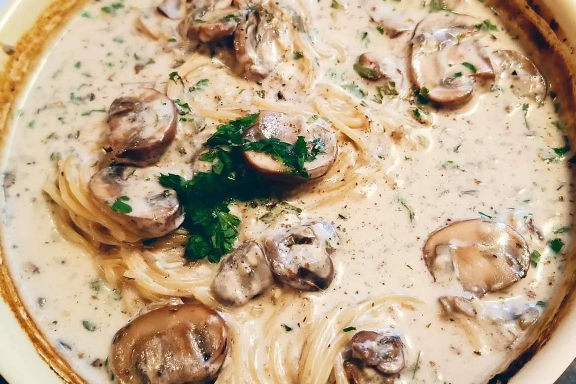 Creamy mushroom pasta dish garnished with parsley and grated cheese
