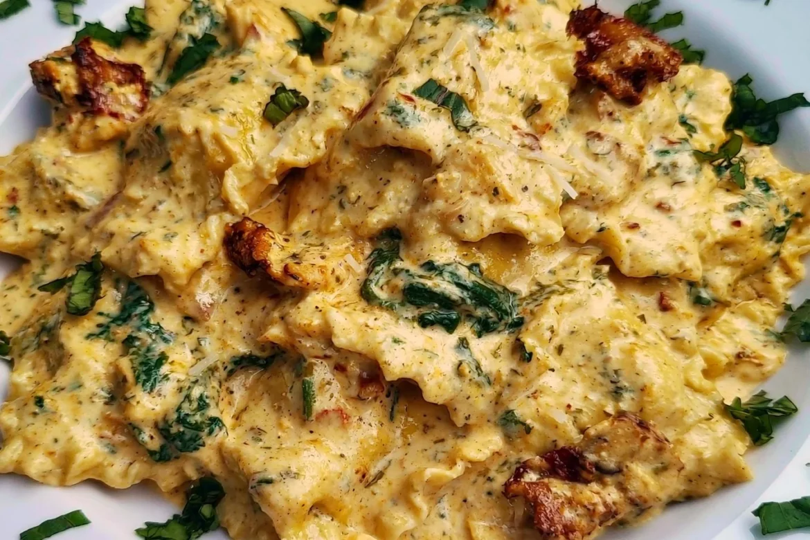 Plate of creamy Tuscan ravioli topped with herbs and sauce