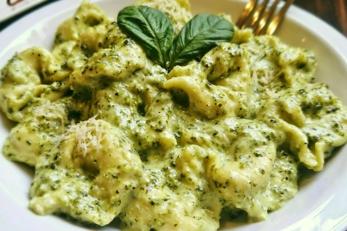 Delicious plate of Pesto Alfredo Tortellini with fresh basil and parmesan