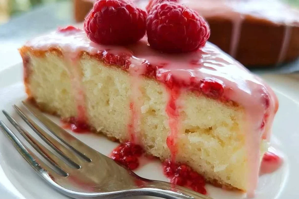 Raspberry Glazed Key Lime Cake topped with vibrant raspberry glaze and fresh lime slices.