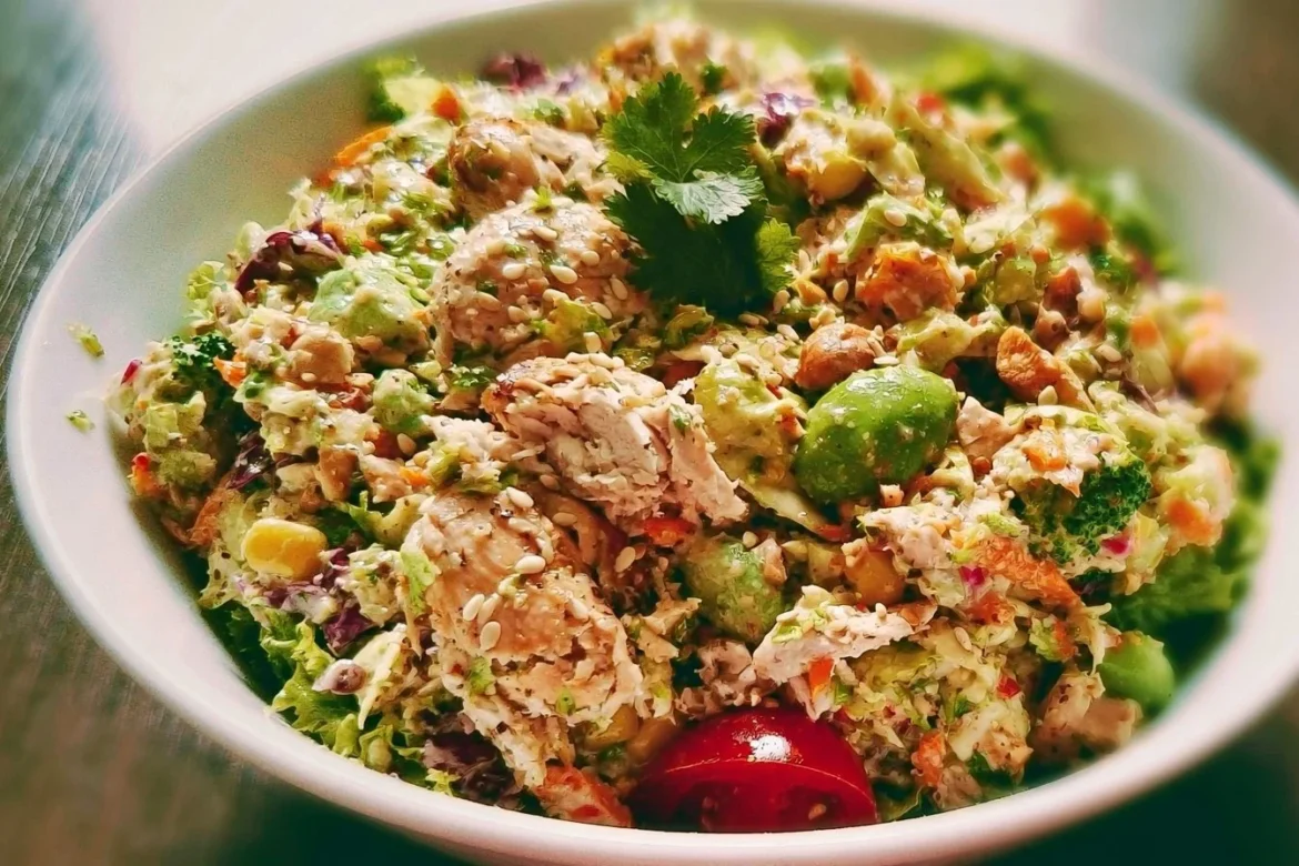 Rotisserie chicken salad with fresh vegetables and dressing