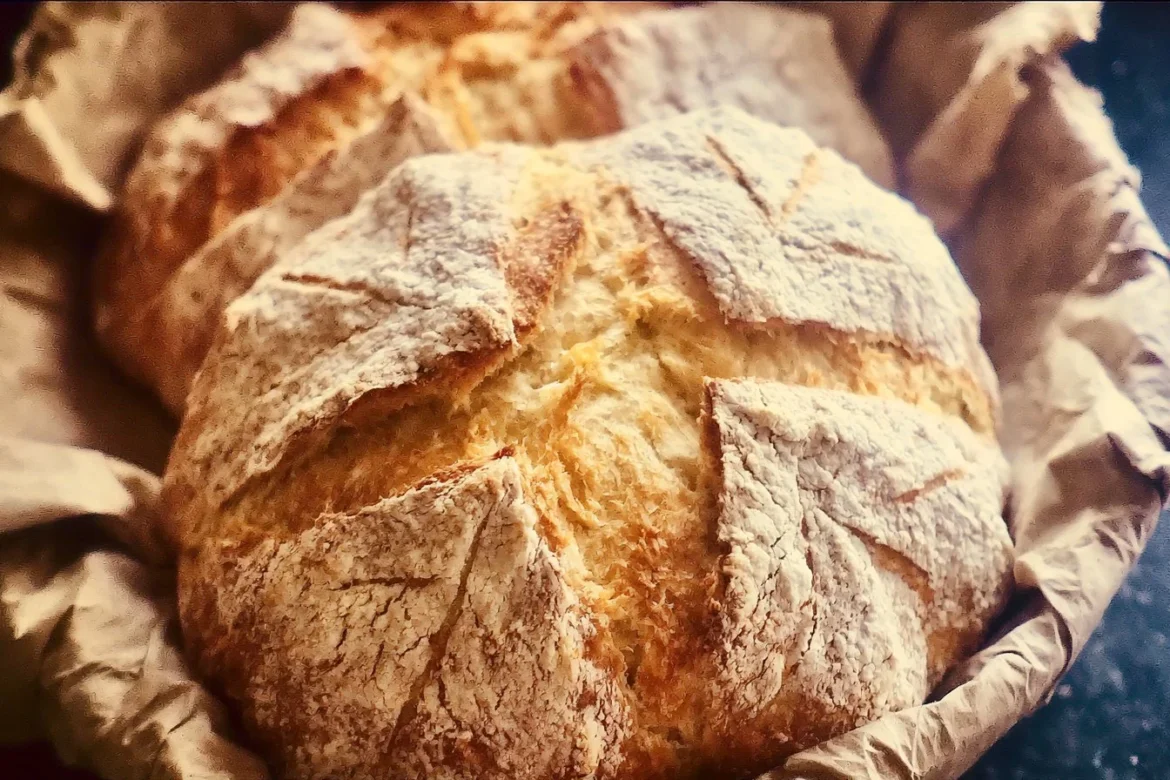 Freshly baked rustic French bread loaf on a wooden table