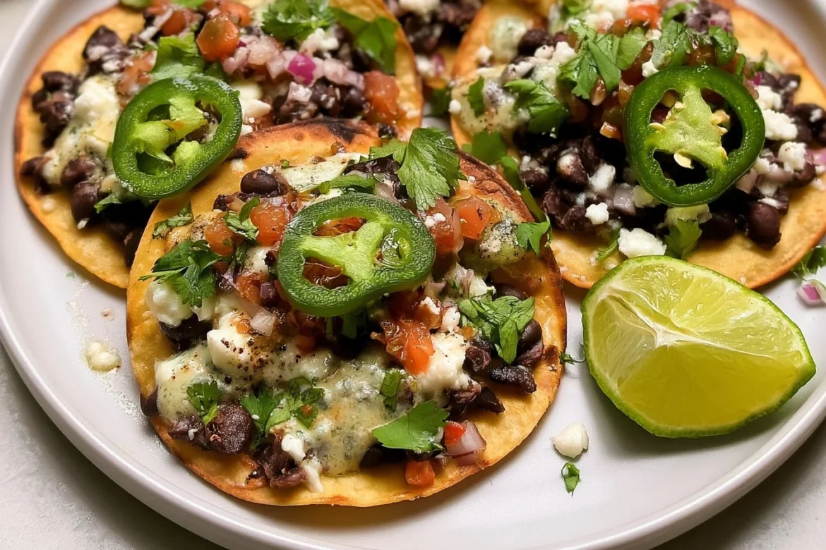 Black bean tostadas topped with fresh vegetables and salsa.