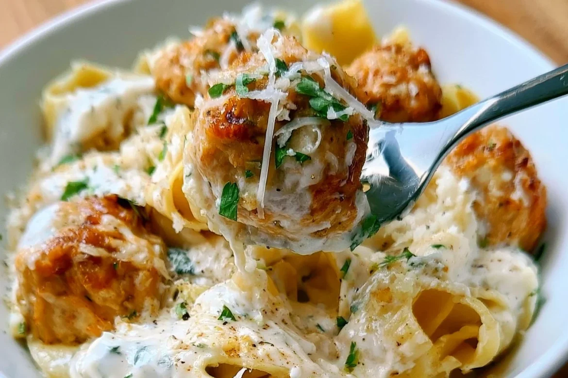 Plate of Chicken Meatball Pappardelle with fresh herbs and sauce