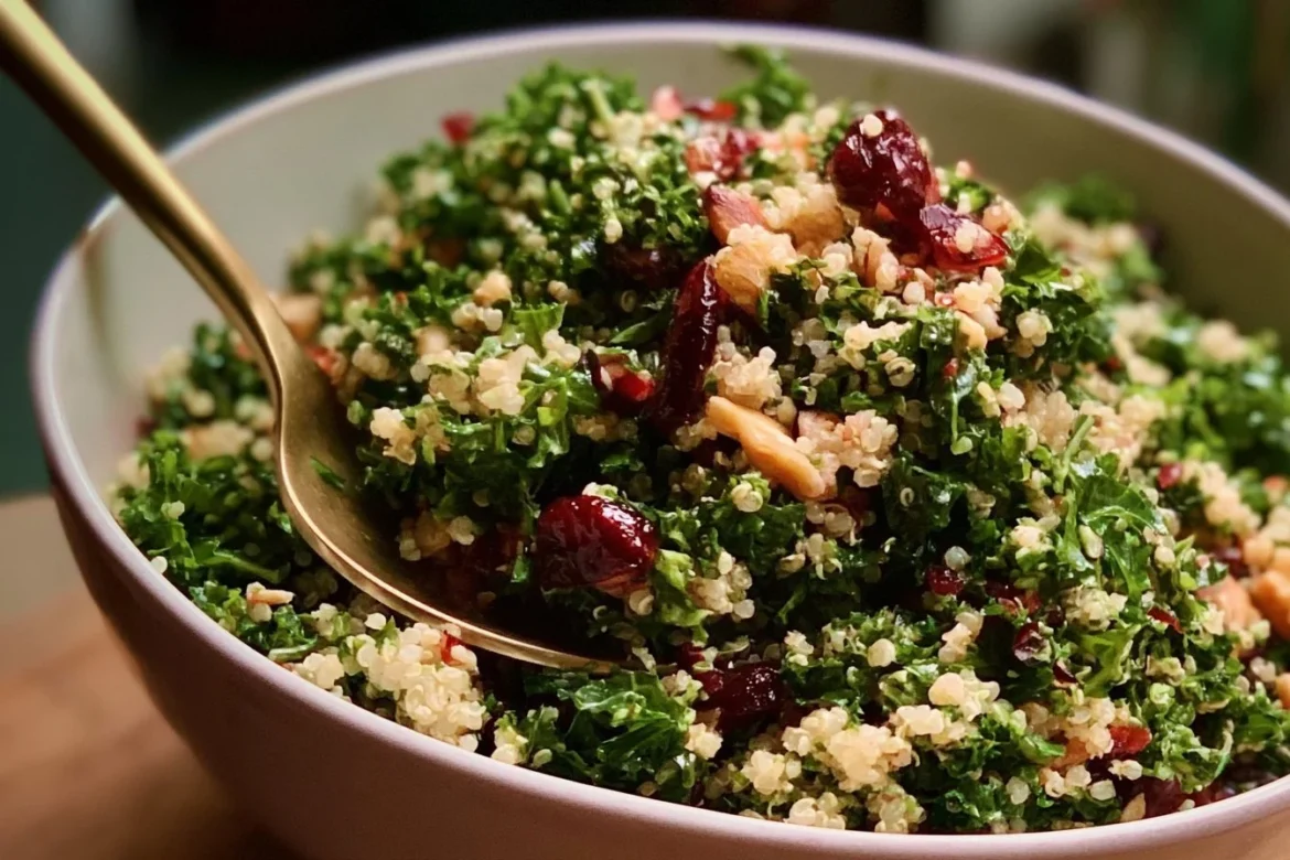 Kale Cranberry Quinoa Salad garnished with nuts and berries in a bowl