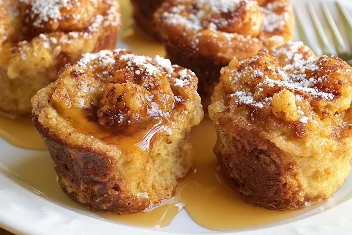 French Toast Muffin Cups baked and garnished with syrup and berries