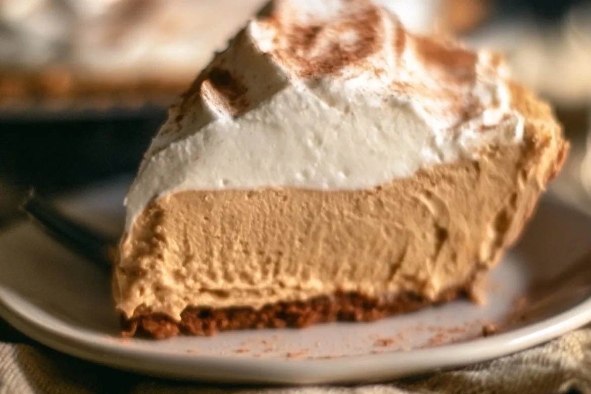 Delicious Gingerbread Cream Pie topped with whipped cream and spices