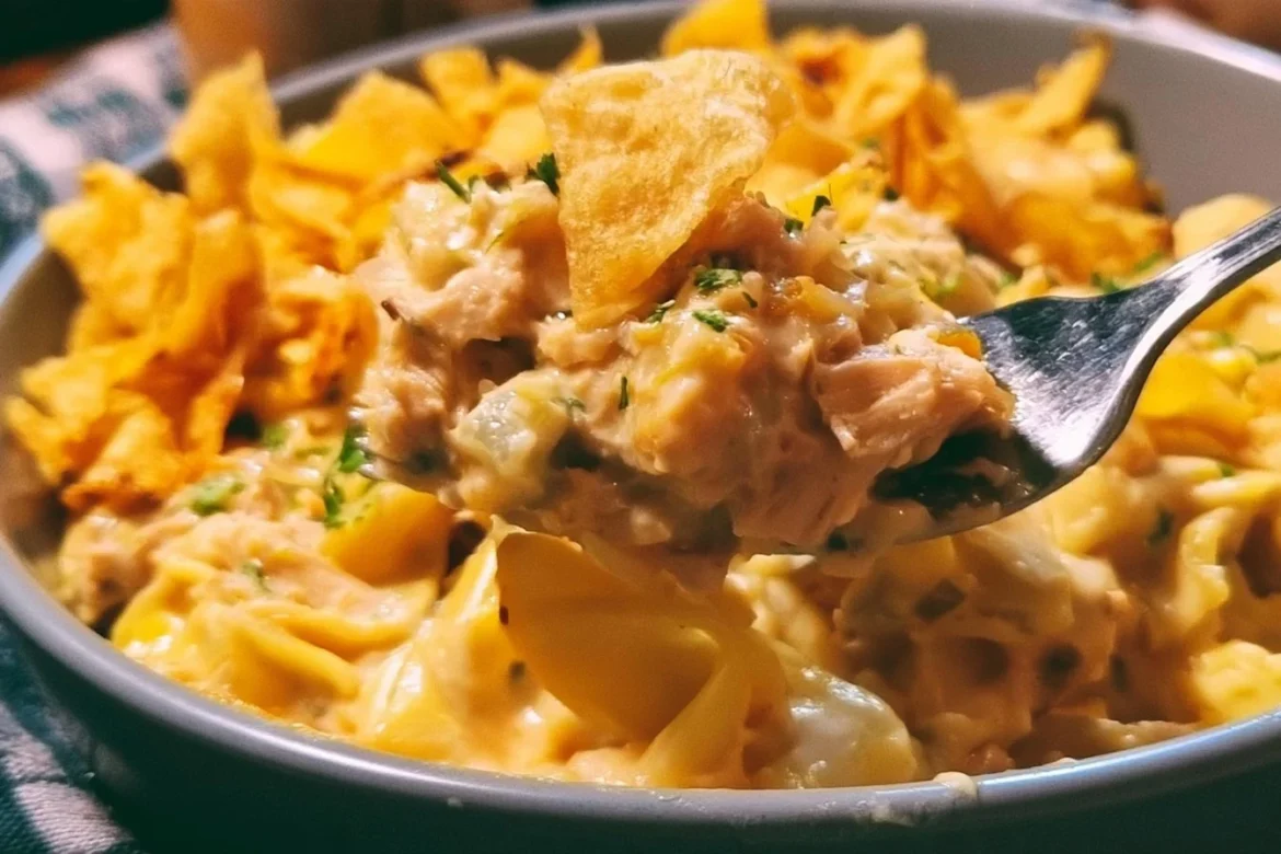 Creamy tuna casserole topped with crispy potato chips in a baking dish